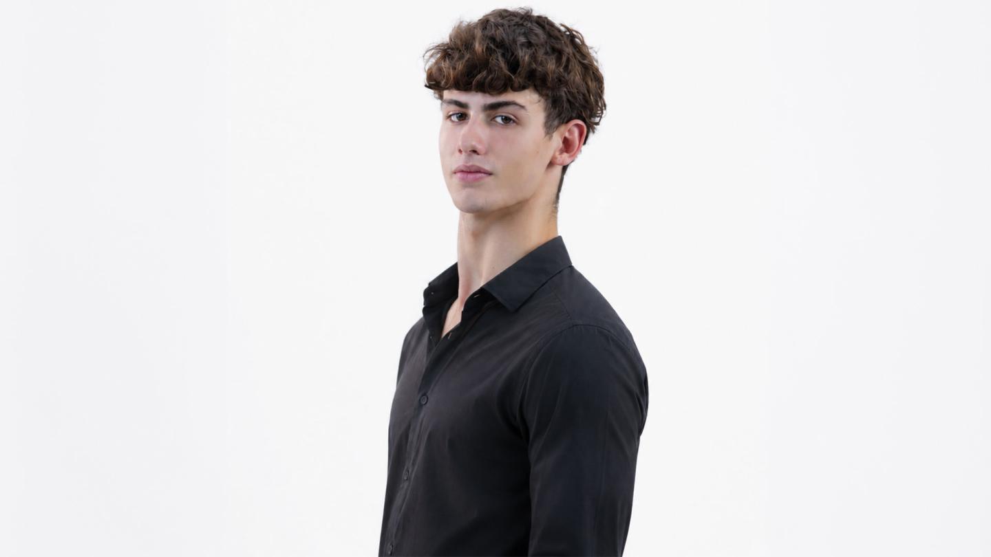 Male in black shirt, and dark, short, curly hair